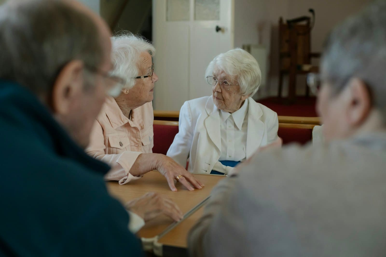 Friends chatting around a table at a meeting