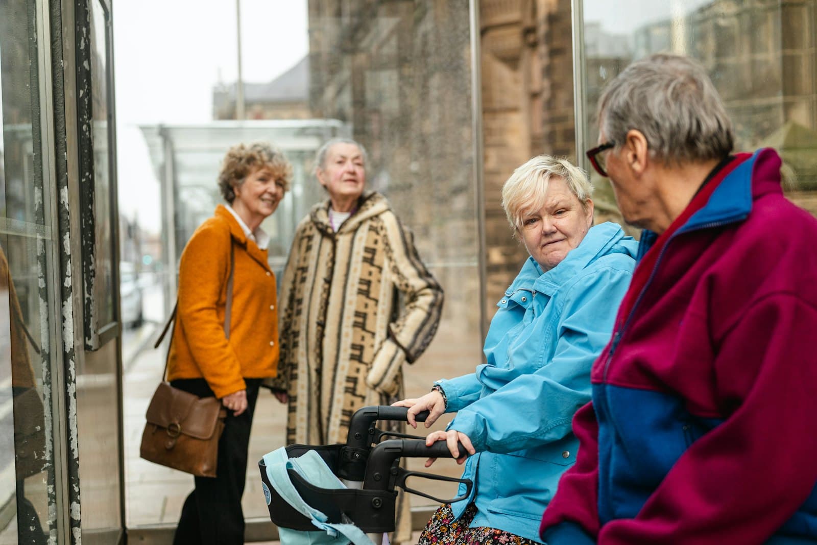 A group of older friends chatting outside on a day out